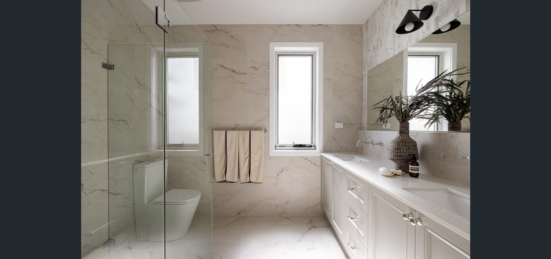 Completed bathroom with double vanity and walk-in shower
