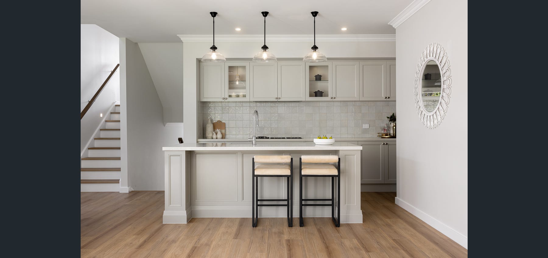 Completed kitchen with island seating and pendant lighting