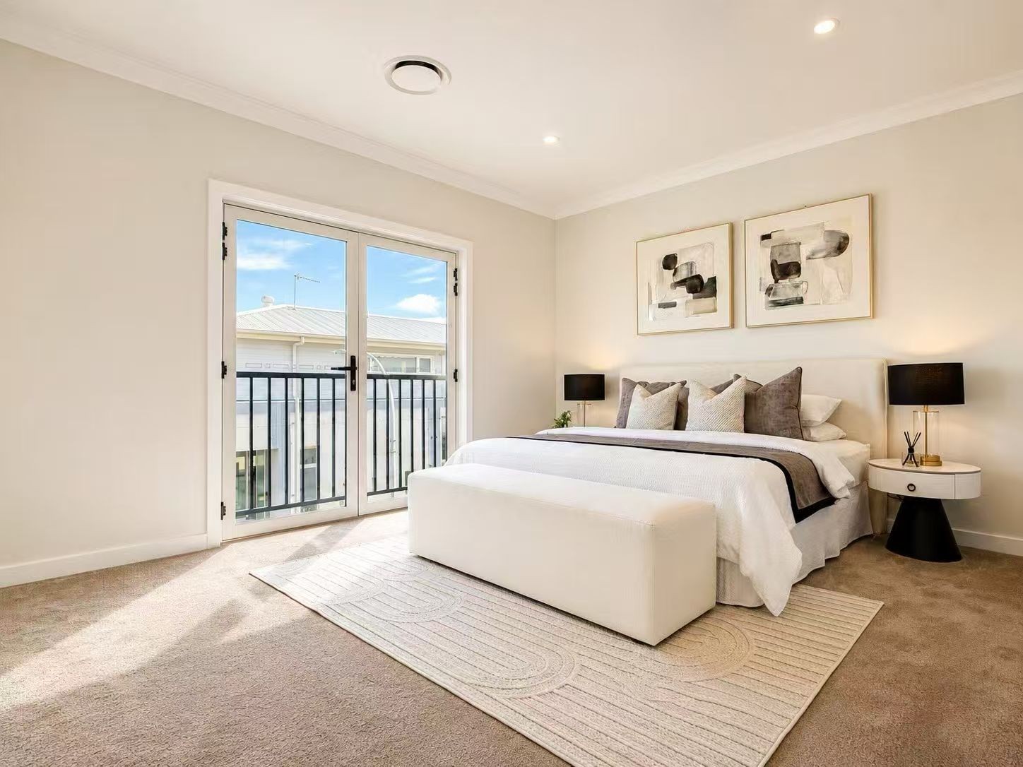 Spacious main bedroom with balcony access