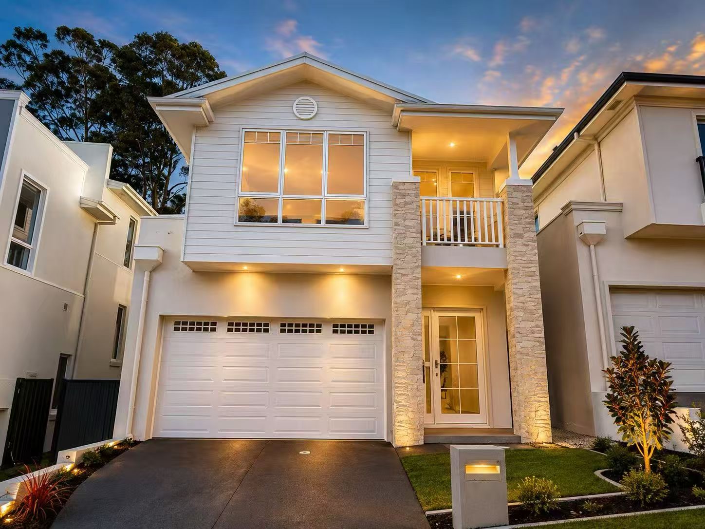 Classic freestanding residence illuminated at dusk